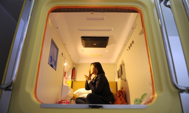 Mandatory Credit: Photo by HAP/Quirky China News / Rex Features (1989248d) A person in their 'room' at the capsule hotel Capsule hotel in Chongqing, China - 24 Nov 2012 Southwest China's first capsule hotel recently opened in Guanyinqiao, Chongqing municipality. The "capsule" hotel features 16 rooms, with each measuring 1.2 meters wide and 2.2 meters long. Each room comes equipped with power supply, clock, wall lamp, TV, air conditioner and WIFI. An overnight stay costs 38 Yuan (GBP 3.80).